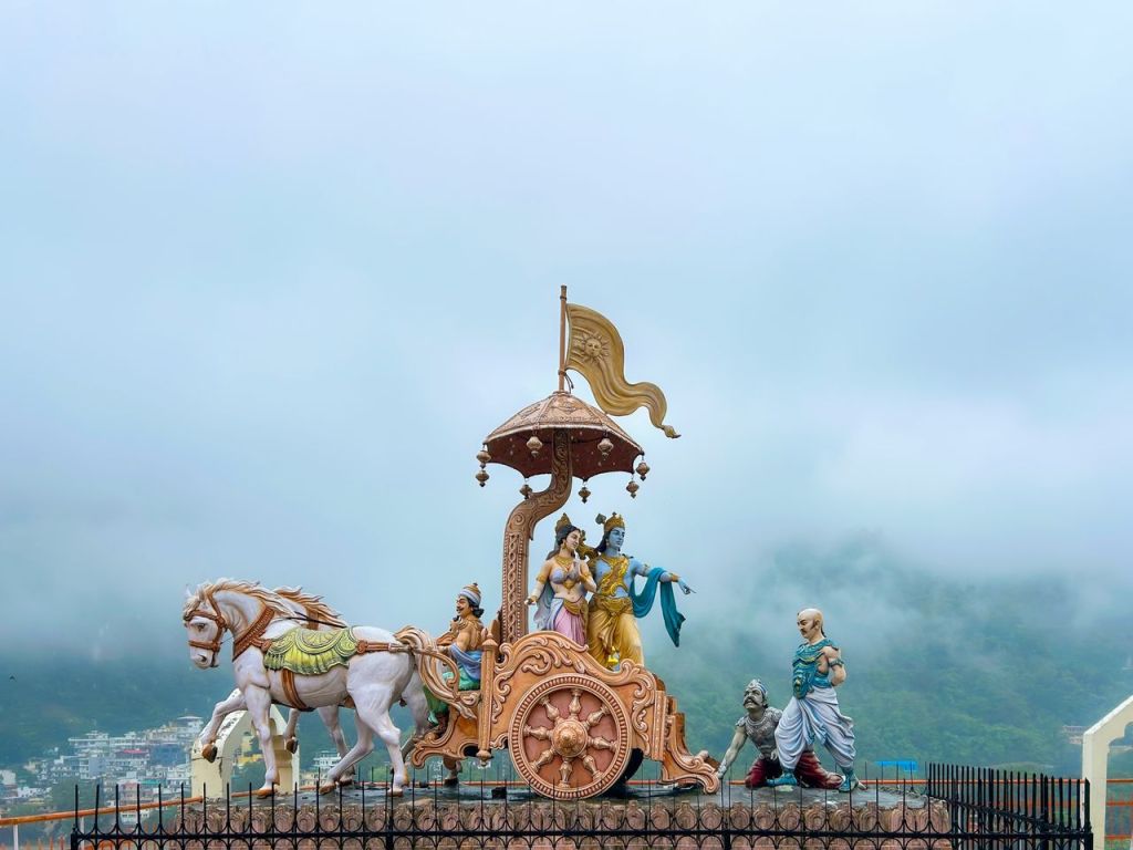 Dramatic sculpture of Krishna and Arjuna on a chariot in Rishikesh, India.